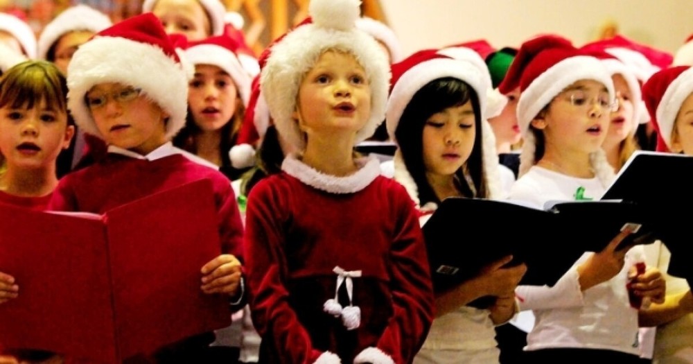children singing in Christmas Choir with Santa hats
